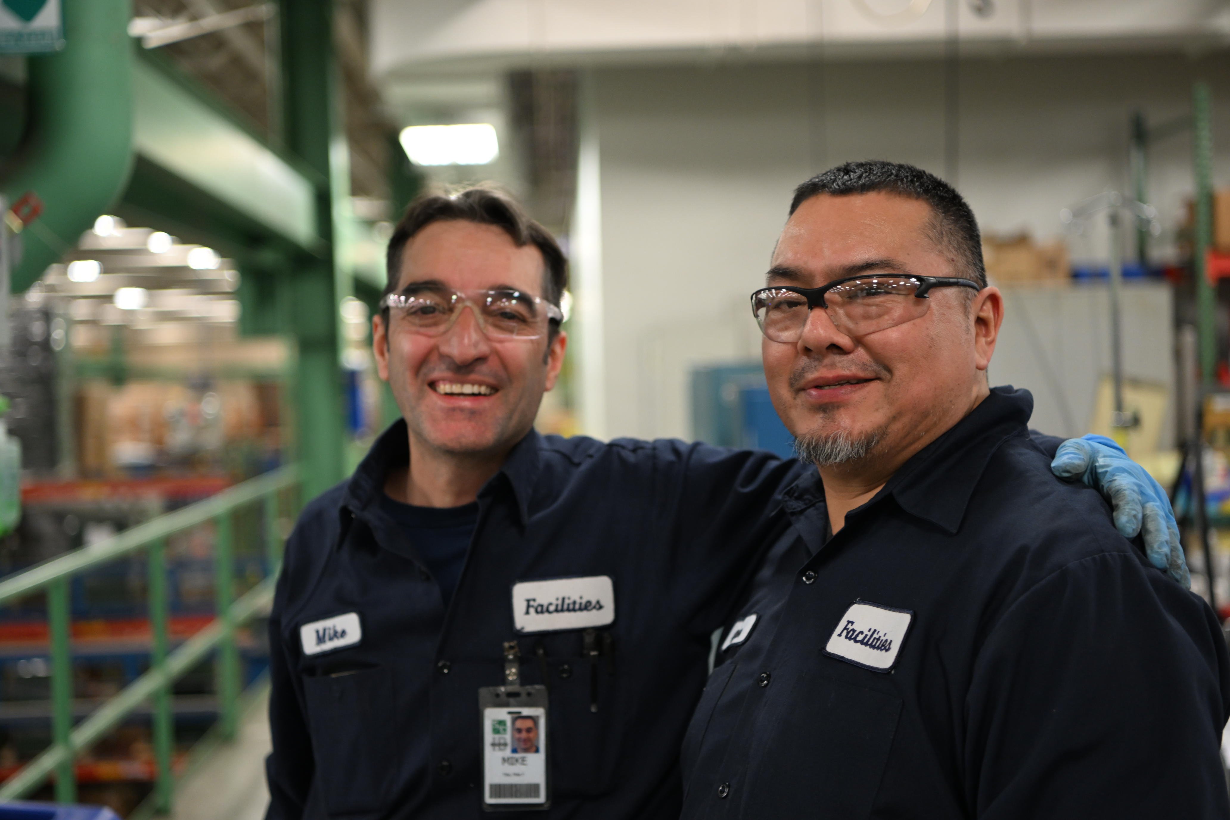 Operational Excellence at S&C Two team members smile for the camera in S&C's manufacturing facility in Chicago, IL.